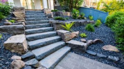 Stone steps to a garden with landscaping. Photo